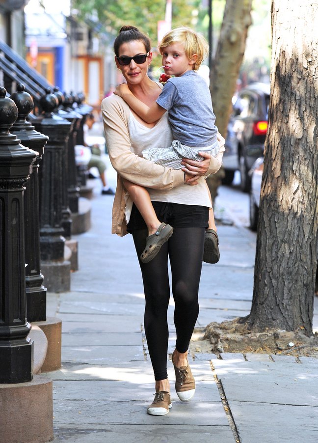 Liv Tyler, black tights, sunglasses, tan sweater, tan shoes